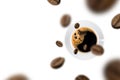 Top view of brown roasted coffee beans falling and flying to coffee cup on white background Royalty Free Stock Photo