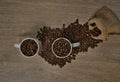 Top view of brown roasted coffee beans spilled on a table with a full coffee mug Royalty Free Stock Photo