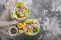 Top view Buddha bowl with chicken meat, bulgur, white beans, quinoa, avocado, lemon and fresh cucumber. Copy space