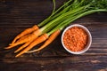 Top view bunch of carrots with condiment in bowl