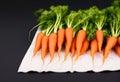 Top view of bunch of fresh organic rainbow carrots on black background