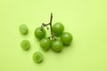 bunch of fresh sweet green shine muscat (vitis vinifera) grape and leaf isolate on green background Royalty Free Stock Photo