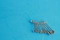 Top view of a bunch of safety pins on a blue background Royalty Free Stock Photo