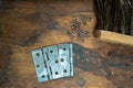 Top view of a bunch of screws and hinges put on the wooden table Royalty Free Stock Photo