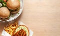 top view burger and french fries on wooden table copy space ai generated Royalty Free Stock Photo