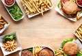 top view of burger and french fries on wooden table with copy space ai generated Royalty Free Stock Photo