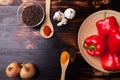 Top view on a burned wooden board with powder spices in spoons n