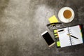 Top view of business desk with coffee, notebook, mobile phone, notes paper and eyeglasses Royalty Free Stock Photo