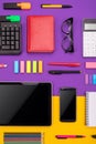 Modern working place with tablet, calculator, notebook and smartphone on purple and orange background. Business concept Royalty Free Stock Photo