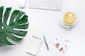 Top view of business desk table with monstera leaves and mock up accessories
