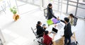 Top view of business partners shaking hands over the table after concluding a business agreement in meeting room with the team. Royalty Free Stock Photo