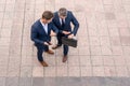 Top view of business partners talk conversation outdoor. Two handsome businessmen in suits discuss a working project Royalty Free Stock Photo