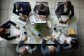 Top view of business people sitting at table and working together in office, Business meeting on a working table, top view, with Royalty Free Stock Photo