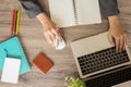 Top view of business woman desk with her hands which are typing on laptop Royalty Free Stock Photo