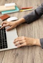 Top view of business woman desk with her hands which are typing on laptop Royalty Free Stock Photo