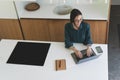 Top view of business woman working from home with laptop, smartphone and notebook