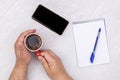 Top view business workspace hands cup of coffee empty copy space notepaper white background table Royalty Free Stock Photo