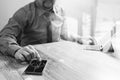 Top view Businessman hand using mobile payments online shopping,omni channel,in modern office wooden desk,icons graphic interface Royalty Free Stock Photo