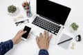 Top view businessman working with modern devices and smartphone, Man hand on laptop keyboard with blank screen monitor Man hand on