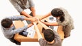 Top view of businessmen and businesswoman standing and stacking hands over table in a meeting copy space isolated white background