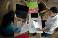 Top view of Businessmen and Businesswomen working with reports and laptop