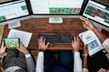 Strategic Path. Top view of businessmen, traders working, using papers and tablet pc, sitting by desk in front of Royalty Free Stock Photo