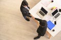 Top view of businesspeople shaking hands after concluding a business agreement. High angle view of businessman standing at the Royalty Free Stock Photo