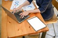 Top view, Businesswoman using laptop, tablet white screen mockup is on the table Royalty Free Stock Photo