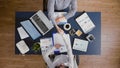 Top view of businesswomen shaking hands before analyzing management statistics paperwork Royalty Free Stock Photo