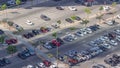 Top view busy parking lot with many cars moving in and out timelapse.