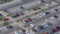 Top view busy parking lot with many cars moving in and out timelapse.