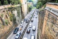 Top view of a busy street in the ancient city of Rome, Italy - Street is full of cars and scooters - Many vehicles stuck in