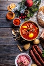 Top of view at cabbage soup - Kapustnica and ingredients for its preparation: Sauerkraut, sausage, smoked neck and knee, potatoes Royalty Free Stock Photo