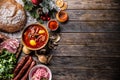 Top of view at cabbage soup - Kapustnica and ingredients for its preparation: Sauerkraut, sausage, smoked neck and knee, potatoes Royalty Free Stock Photo