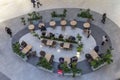 Top view of a cafe with resting people in a shopping mall. Business meetings and shopping