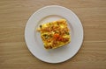 Top view of cake slice with icing, walnut and pumpkin seeds