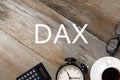 Top view of calculator,clock, a cup of coffee,sunglasses on wooden background written with DAX Royalty Free Stock Photo