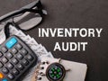 Top view calculator,glasses,compass and banknotes with text INVENTORY AUDIT Royalty Free Stock Photo