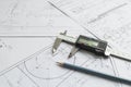 Top view of a caliper measuring tool, pencil and detail drawings.Engineering drawings, metal detail Royalty Free Stock Photo