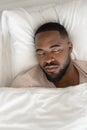 Top view of calm biracial man relax sleeping in bed