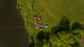 Top view of camp of tourists with tents on the river bank.