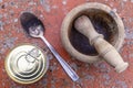 Top view of a can of packaged food, a wooden mortar and a metal spoon on a spotted background Royalty Free Stock Photo