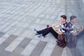 Top view of candid boy listening music and eating in downtown