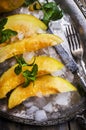 Top view of cantaloupe melon slices with mint and ice served  on vintage sliver plate Royalty Free Stock Photo