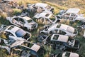 Top view of the car graveyard. Broken old rusty cars lying on the grass