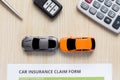 Top view of car insurance claim form with car toy on wooden desk Royalty Free Stock Photo