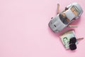 Top view of car model and Thai banknotes on pink colour backgrou