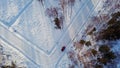 Top view of car on suburban winter road. Action. Red car is parked at intersection of roads marked in snow. Suburban