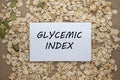 Top view of card with text Glycemic index on oat and seeds background. Healthy eating concept Royalty Free Stock Photo