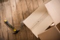Top view of cardboard boxes with hammer and nails on wooden floor Royalty Free Stock Photo